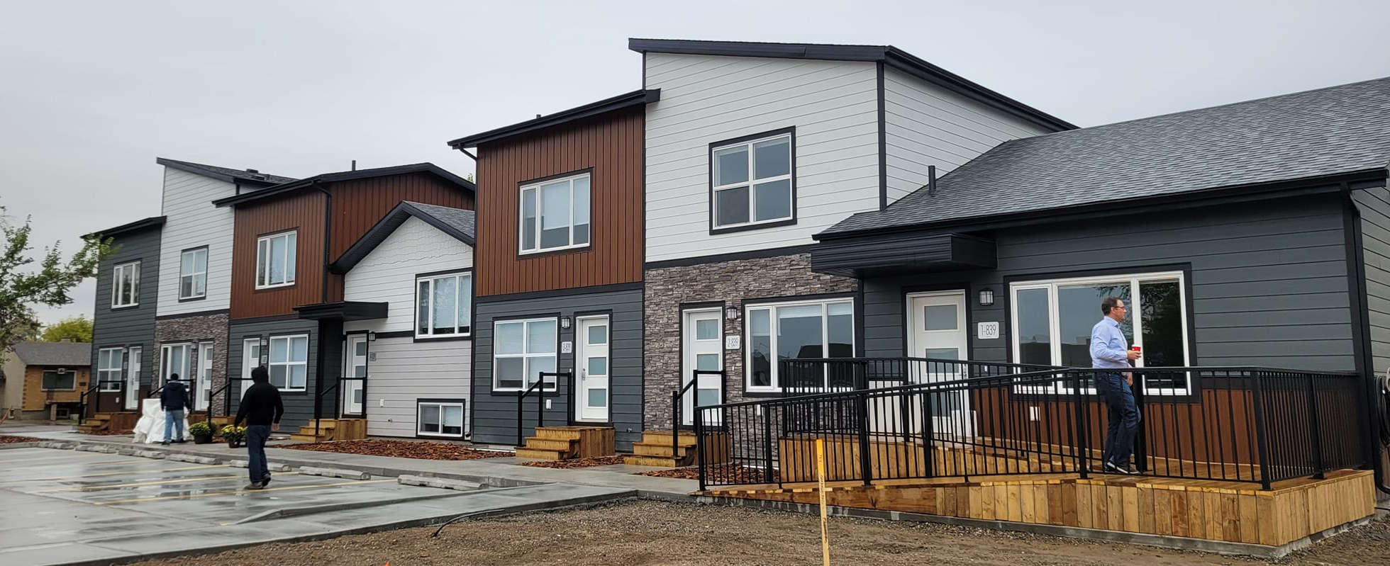 Newly build low income housing showing a row of four houses. One with a weelchair accessible ramp